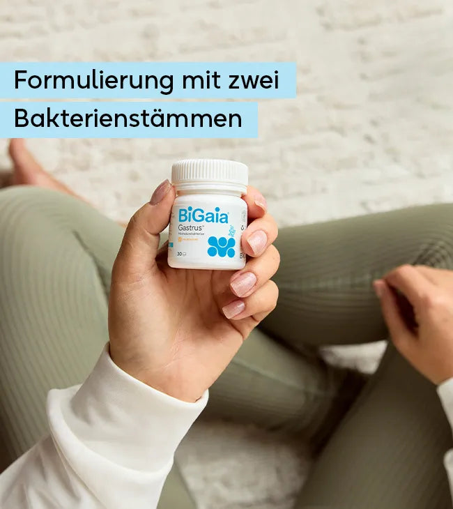 Eine Person in Sportkleidung hält die BiGaia Gastrus Dose. Der Text oben links lautet: Formulierung mit zwei Bakterienstämmen.